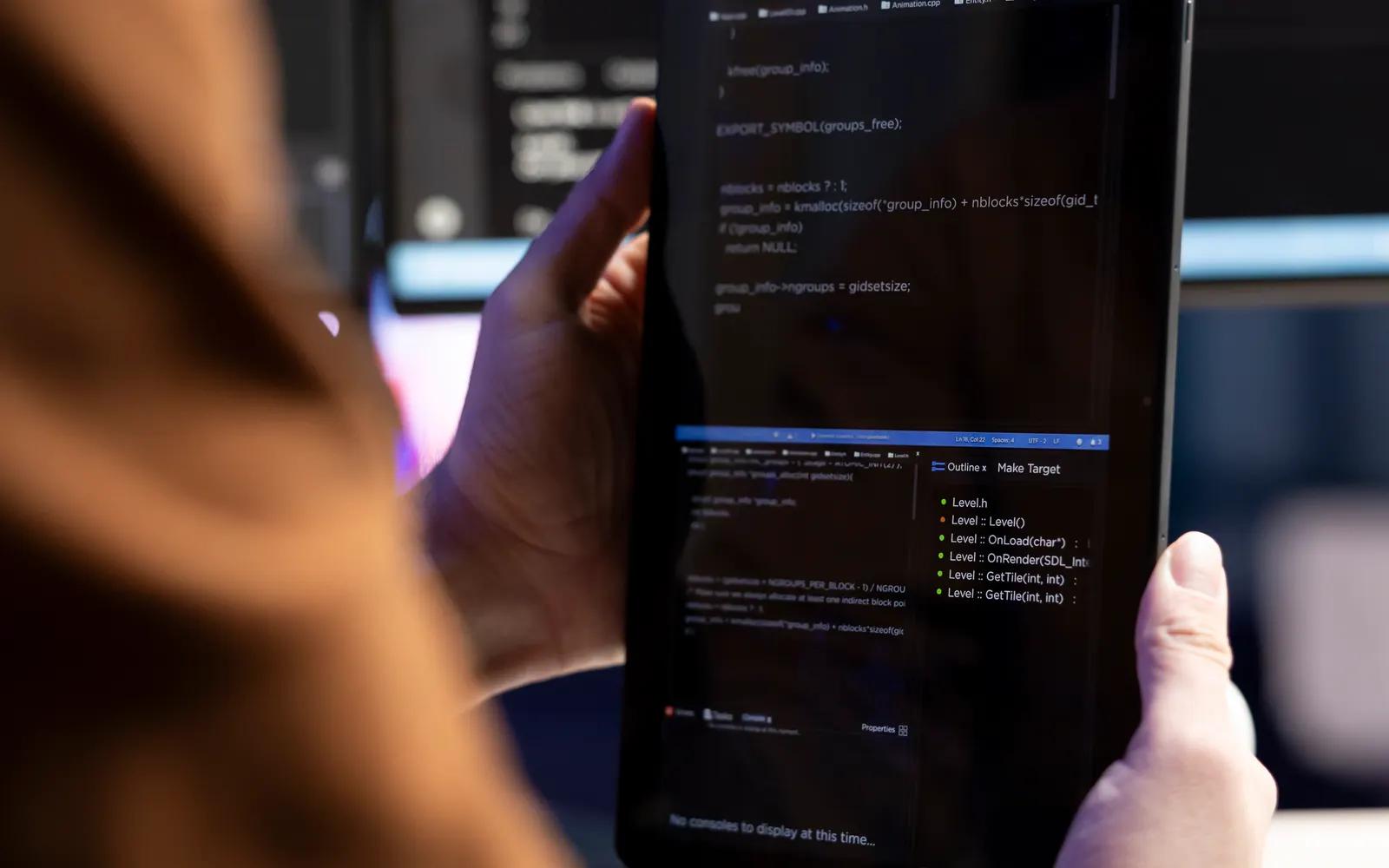 Developer designing a mobile application on a tablet