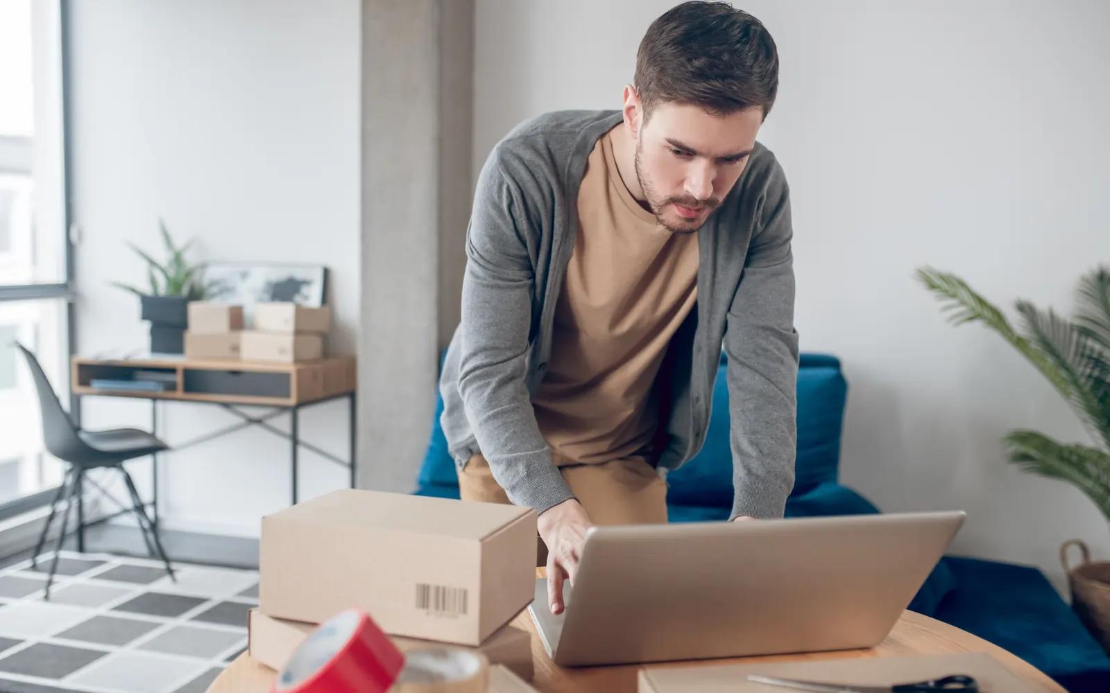 Online store employee managing product listings on a laptop